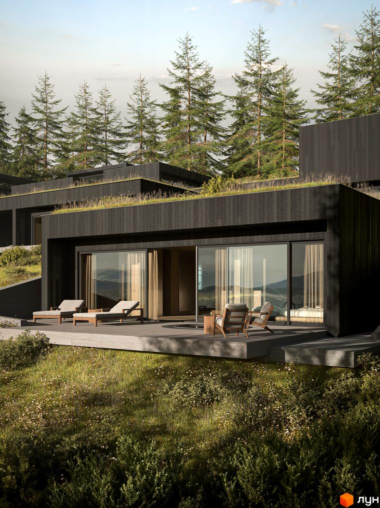 Будинок з темного дерева з зеленим дахом, розташований серед дерев. Тераса з шезлонгами та кріслами, що виходить на гірський пейзаж.
