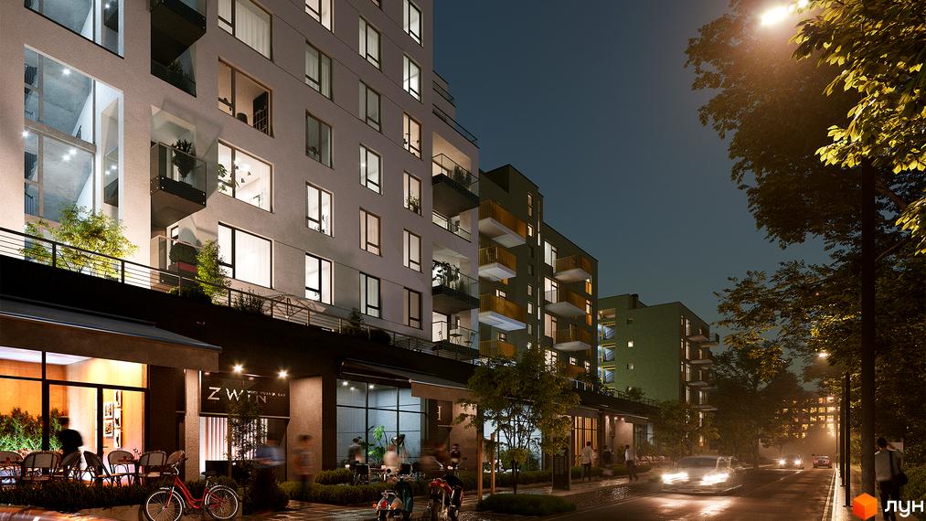 Житловий комплекс HYGGE LUX вночі. Фасад будинку з балконами та вікнами, освітлена вулиця з деревами та автомобілями.