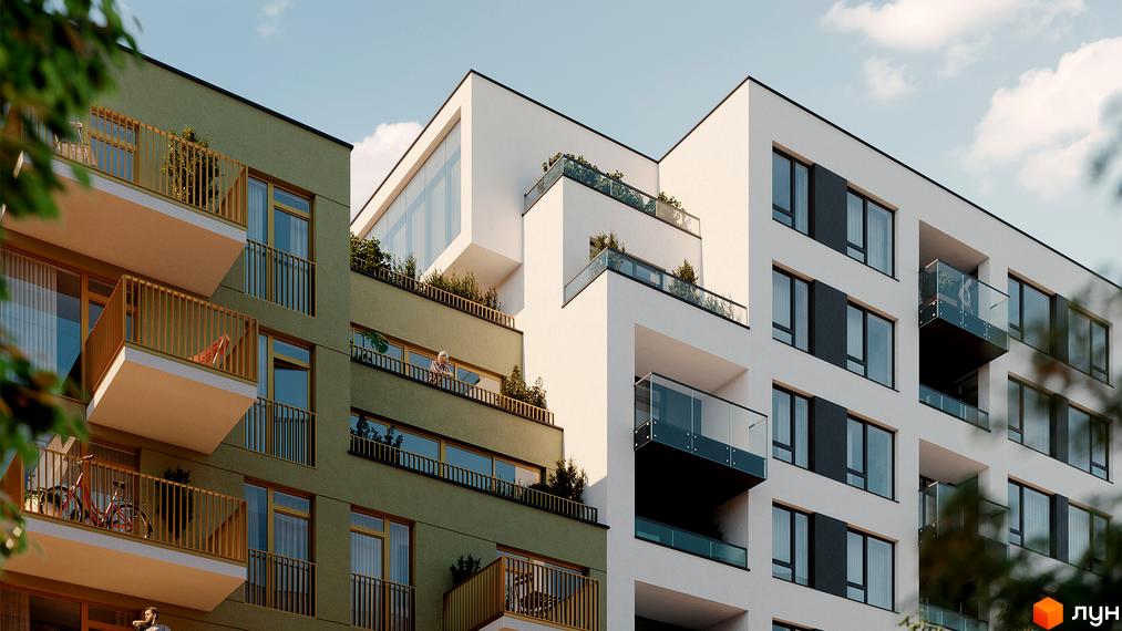 Зовнішній вигляд житлового комплексу HYGGE LUX з зеленими та білими фасадами, балконами та вікнами. На прибудинковій території видно дерева та рослини.