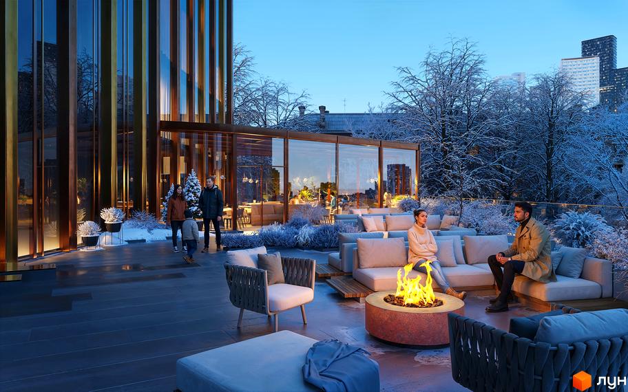 Зовнішній вигляд комплексу THE ONE з панорамними вікнами та терасою з каміном та зонами відпочинку взимку.
