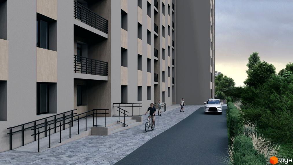 Фасад багатоповерхового будинку Житлового комплексу Браво з сірими стінами та дерев'яними вставками. Прибудинкова територія з пандусом, вимощеними доріжками та зеленню.