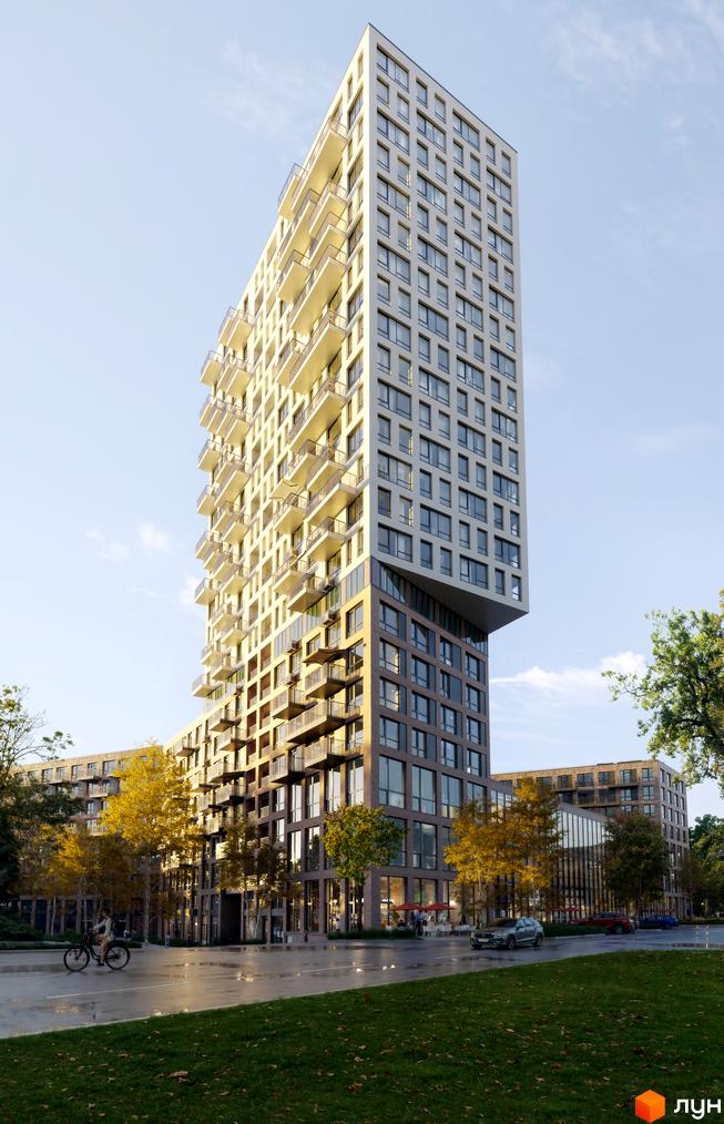 Житловий комплекс The TENTH House - висотна будівля з балконами та великою кількістю вікон на тлі блакитного неба. На передньому плані зелена галявина та дорога з деревами.