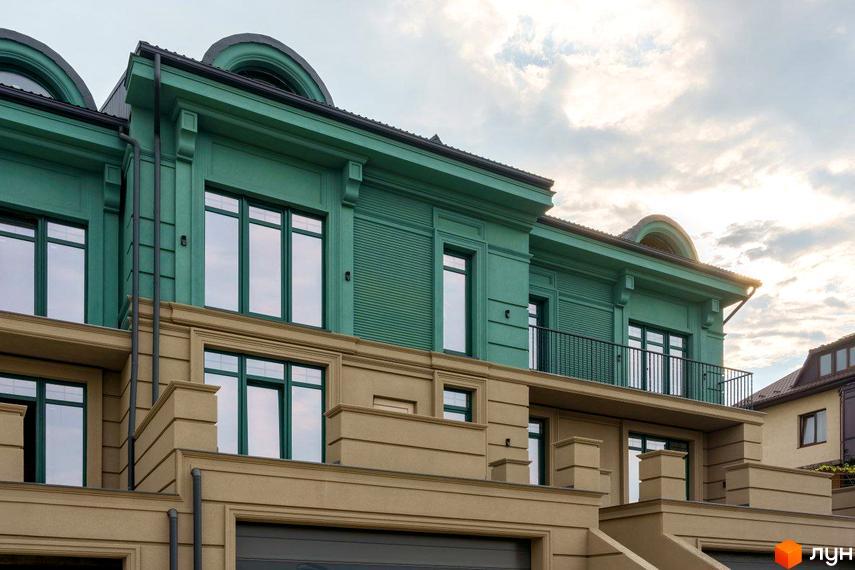 Таунхаус Green Life з зеленим фасадом та бежевим цоколем, вікна з темними рамами, балкон з кованою огорожею.