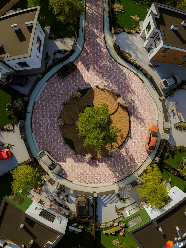 Котеджне містечко Barcelona: вид зверху на будинки з пласкими дахами та прибудинкову територію з круглою брукованою площею та деревами.