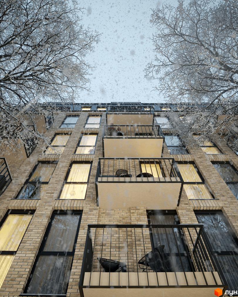 Зовнішній вигляд новобудови ЖК Avalon Yard у зимовий період з деревами, вкритими снігом, та падаючим снігом.