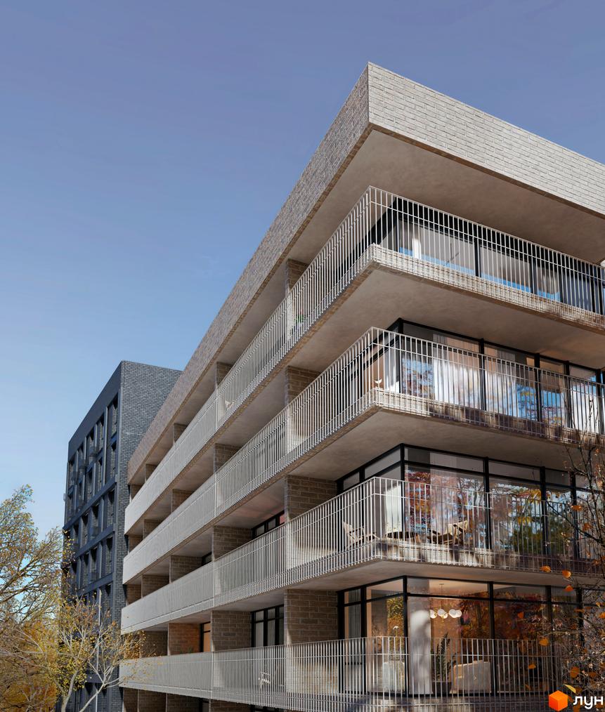 Фасад житлового комплексу ORLAN RESIDENTS з цегляним оздобленням та балконами з білими перилами. Поруч розташована сусідня будівля та дерева з осіннім листям.