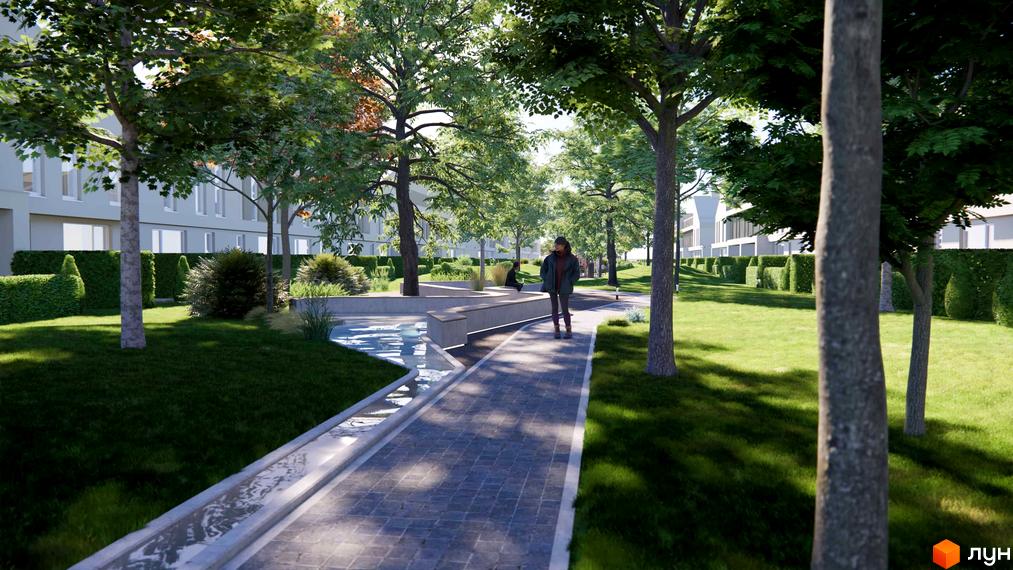 Зображення прибудинкової території таунхаусів 4 Lines. На фото алея з бруківки, дерева та зелені насадження.