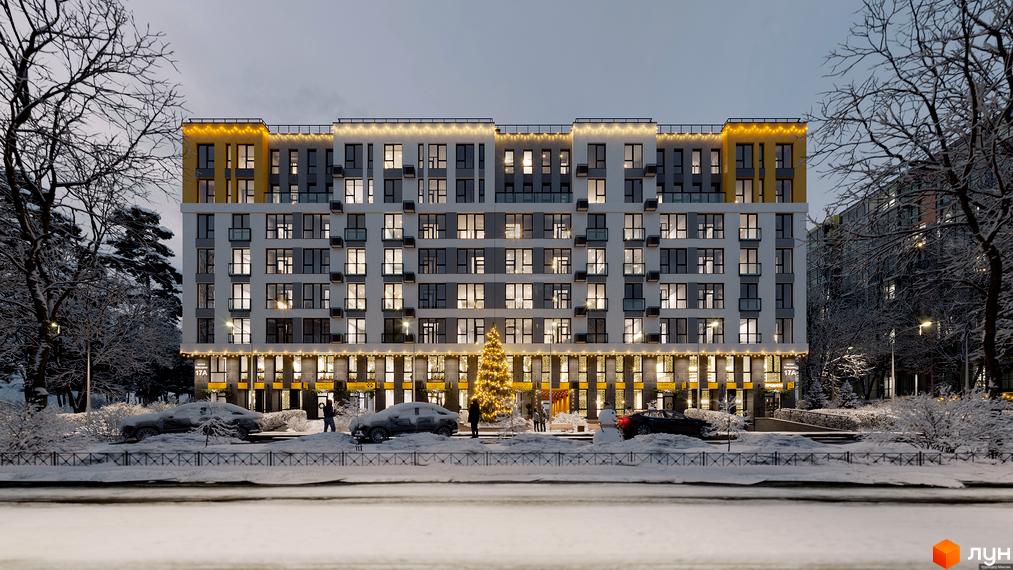 Зовнішній вигляд житлового комплексу Весняний у зимовий період з новорічною ялинкою та автомобілями на подвір'ї. Комплекс має багато вікон та балконів, а також декоративне освітлення.