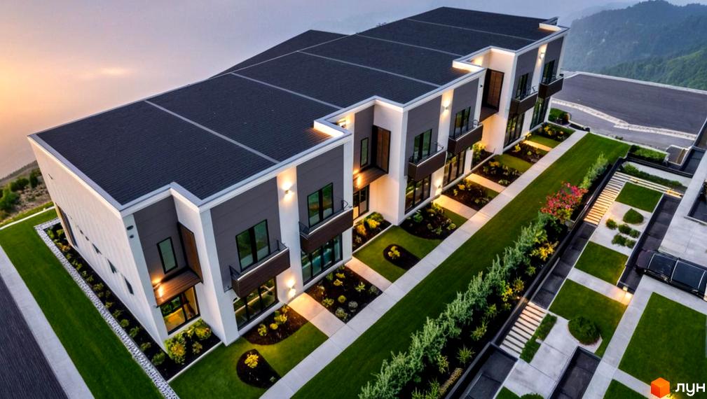 Житловий комплекс Elite Home II: ряд будинків з плоскими дахами, світлими фасадами та балконами. Доглянута прибудинкова територія з газонами та доріжками.