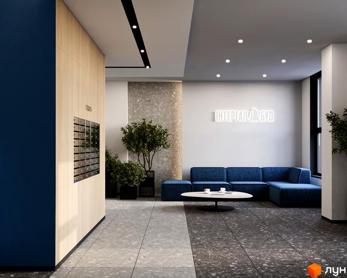 Інтер'єр холу житлового комплексу River City з диваном, кавовим столиком та поштовими скриньками.