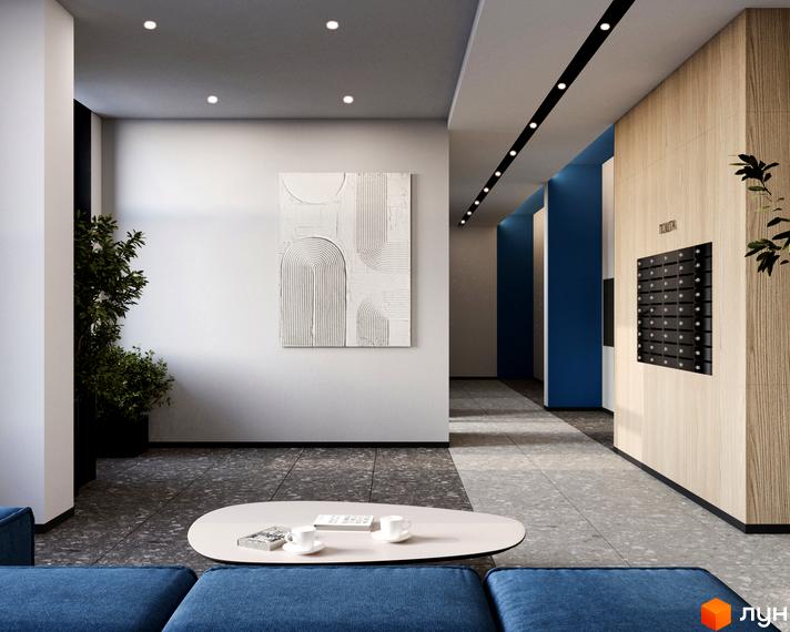 Сучасний хол ЖК Рівер Сіті з арт-об'єктом на стіні та зоною відпочинку. Стильні поштові скриньки на дерев'яній панелі.