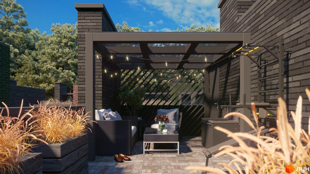 Таунхауси Madera House з цегляним фасадом та зоною відпочинку під навісом з вуличними меблями та спортивним обладнанням. Навколо зелені дерева та блакитне небо.