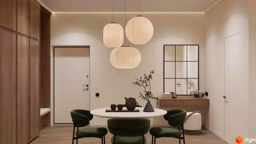 Інтер'єр їдальні в житловому комплексі КМ FOMICH TOWN з круглим столом, зеленими кріслами та підвісними світильниками. Дизайн кімнати виконаний в спокійних тонах з дерев'яними елементами.