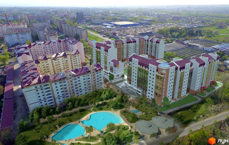 Житловий комплекс Затишна оселя: вигляд багатоповерхових будинків з червоними дахами та басейном на прибудинковій території. Панорамний вид на місто.