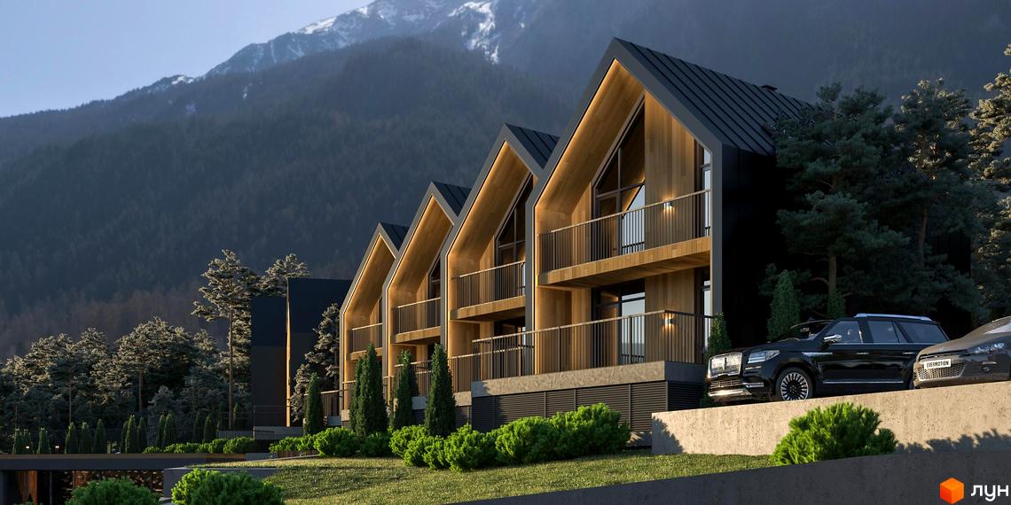 Котеджне містечко SKELYAR з дерев'яними фасадами та темними дахами на тлі гір. На території комплексу облаштована прибудинкова територія з газоном та деревами.