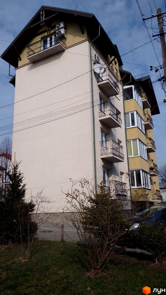 Будинок на вул. Новий Світ, 17а, з балконами та кондиціонерами, оточений деревами та зеленою зоною.