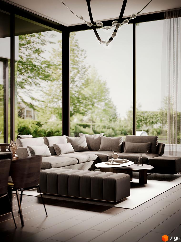 Інтер'єр вітальні в котеджному містечку Equides Villas з панорамними вікнами та видом на зелену прибудинкову територію. Затишна зона відпочинку з диваном та кавовими столиками.