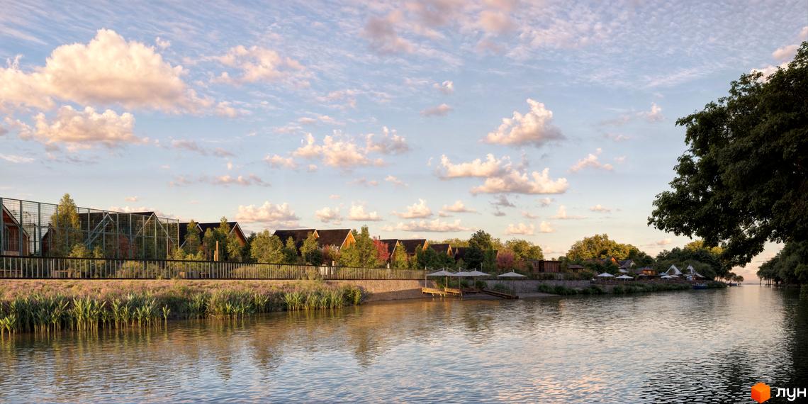 Котеджне містечко Ovillas з дерев'яними будинками та зеленими насадженнями біля річки. Територія комплексу облаштована парасольками та дерев'яними пірсами.