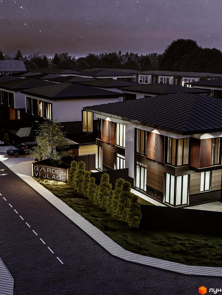 Котеджне містечко Garden Village Petropavlivka вночі. Сучасні будинки з великими вікнами та темними дахами, освітлена дорога та зелені насадження.