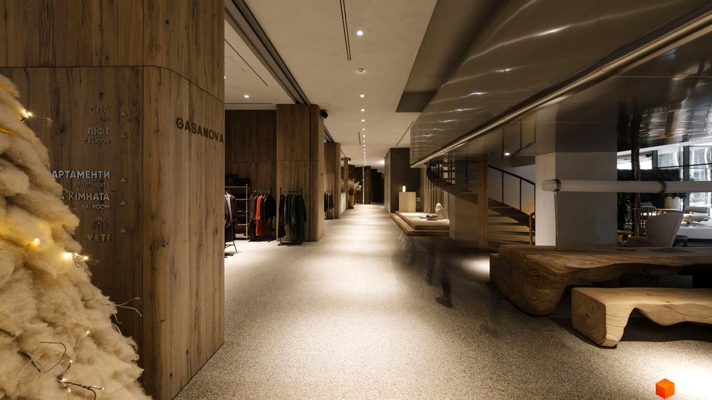 Апарт-комплекс Mountain Residence: вхідна група з дерев'яними елементами та покажчиками напрямку. Дизайнерський інтер'єр лобі з меблями з натурального дерева.