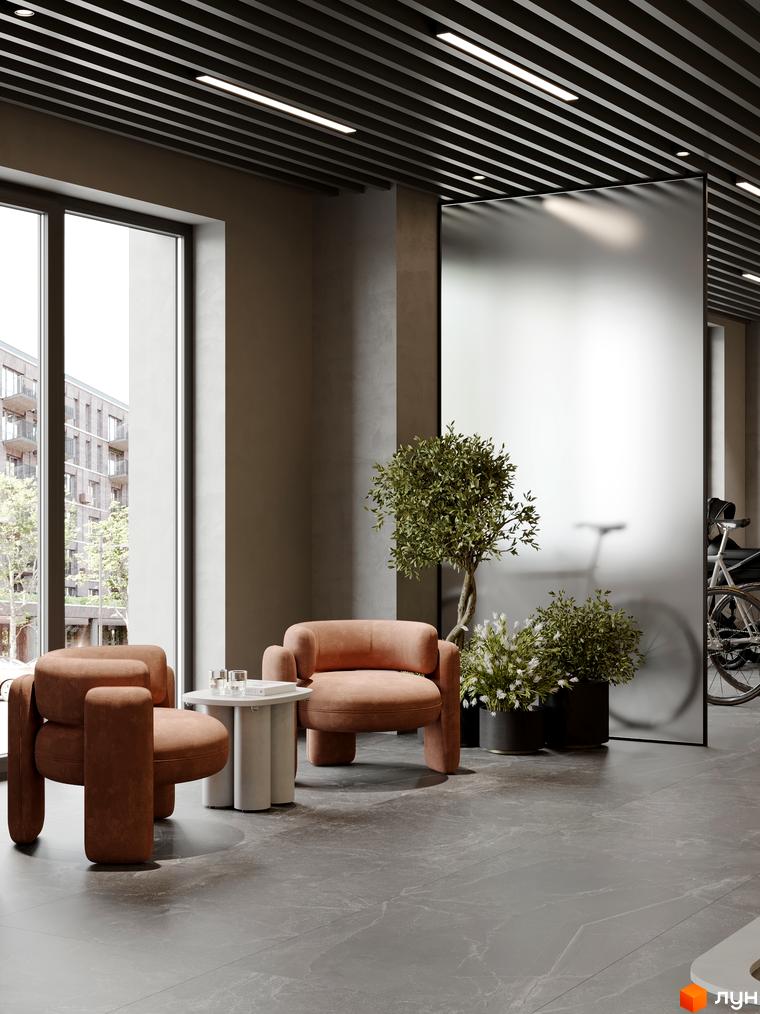 Житловий комплекс AVANT PARK: затишна зона відпочинку з меблями та рослинами біля великих вікон з видом на міську забудову.