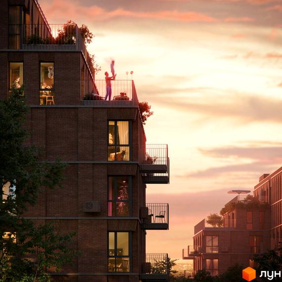 Житловий комплекс AVANT PARK з фасадами з цегли та балконами на тлі вечірнього неба. На верхньому поверсі чоловік підкидає дитину.
