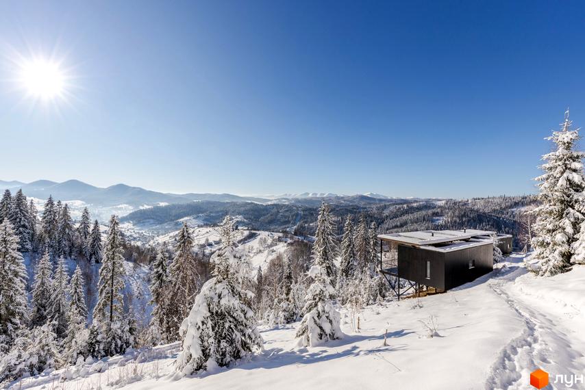 Котеджне містечко Висота 890 взимку. Сучасна архітектура будинків на тлі засніжених гір та лісів.