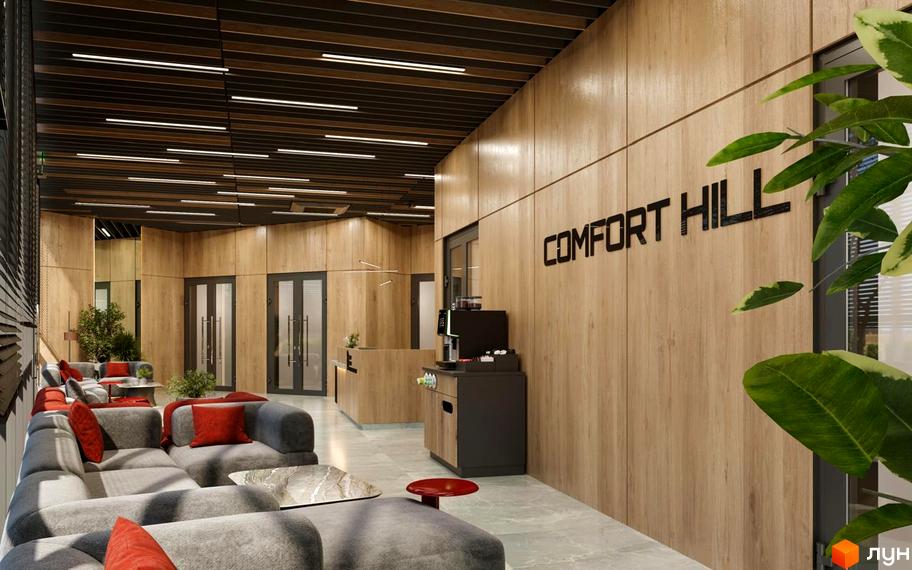 Просторий інтер'єр лобі Житлового комплексу Comfort Hill з дерев'яними панелями на стінах, м'якими сірими диванами та кавовою зоною.