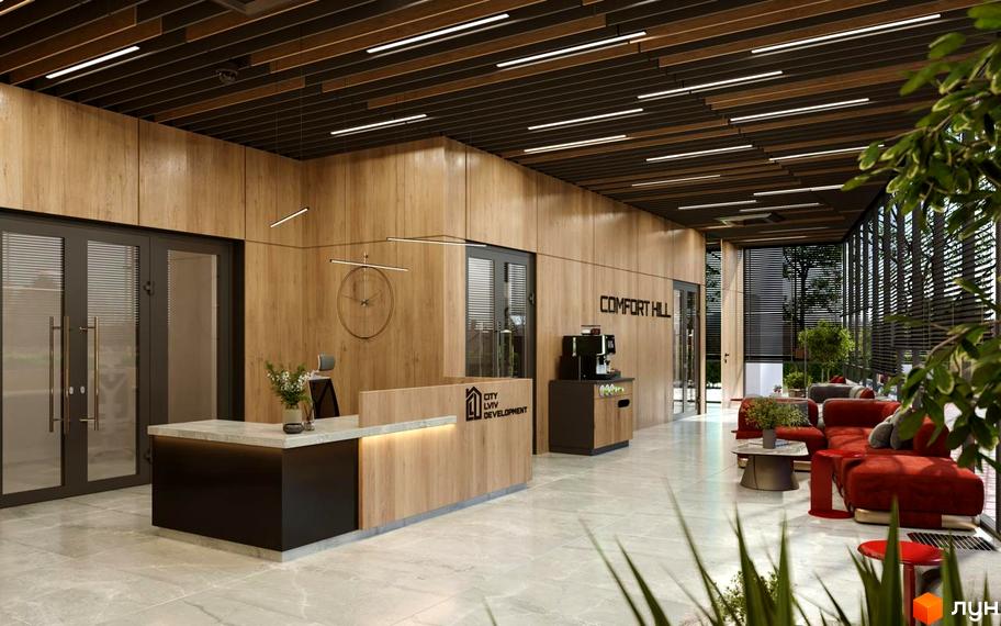Інтер'єр холу в Житловому комплексі Comfort Hill. Ресепшн з логотипом забудовника, зона очікування з червоними диванами, панорамні вікна.