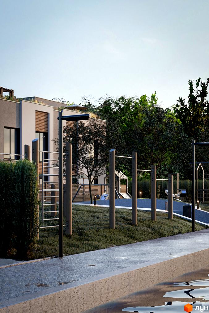 Будівля Котеджного містечка The Lake з світлим фасадом та дерев'яними елементами, поруч облаштована прибудинкова територія зі спортивним майданчиком.