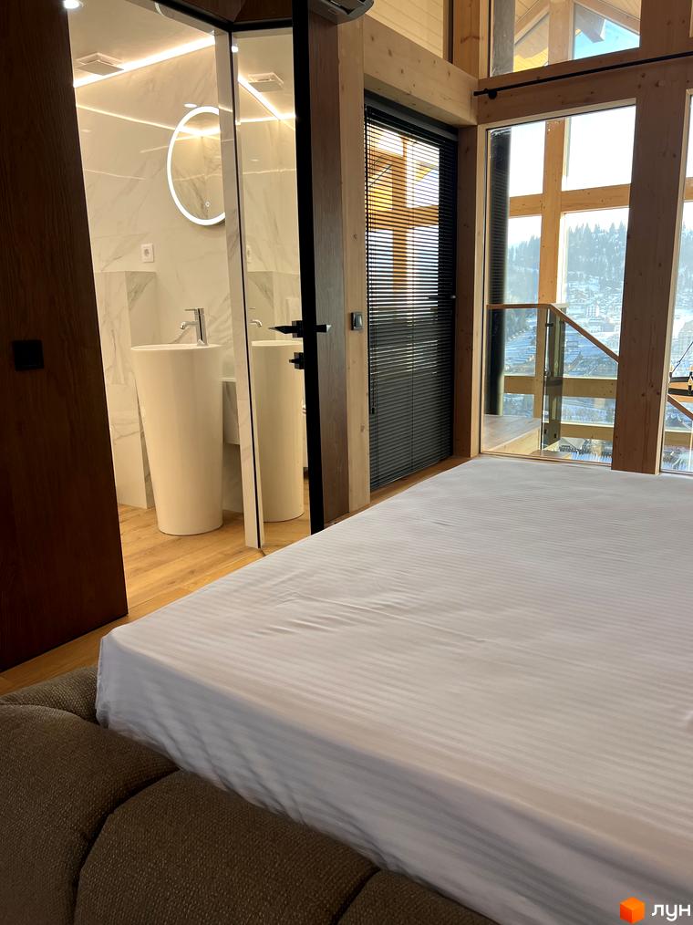 Кімната в Котеджному комплексі Шале Вище Неба з панорамними вікнами та видом на гори. Простора спальня з білою постільною білизною.