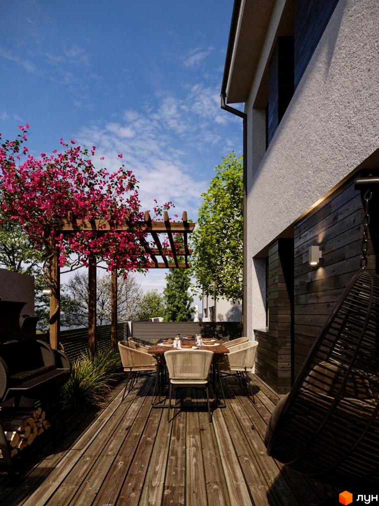 Зображення фасаду будинку в Котеджному комплексі КМ Company Village з терасою, столом та кріслами для відпочинку.