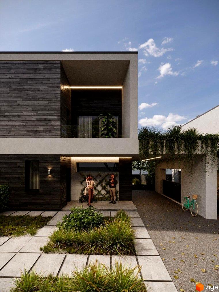 Будинок Котеджного містечка Company Village з темним дерев'яним фасадом та світлими бетонними елементами. Доріжки з плит та зелені насадження біля входу.