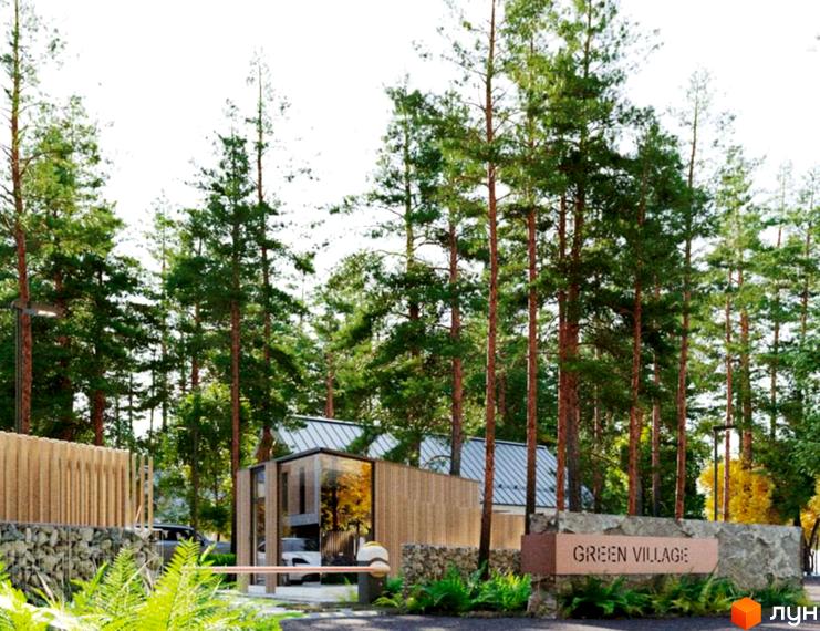 Пропускний пункт Котеджного містечка Green Village зі скляними та дерев'яними елементами, розташований серед високих сосен та кам'яної огорожі.