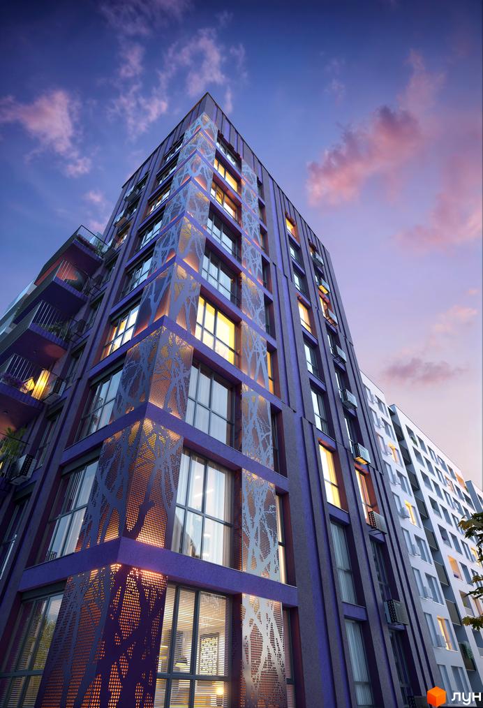 Новобудова Lavanda Park з фіолетовим фасадом та декоративними перфорованими панелями. Вечірній вигляд будівлі з освітленими вікнами.