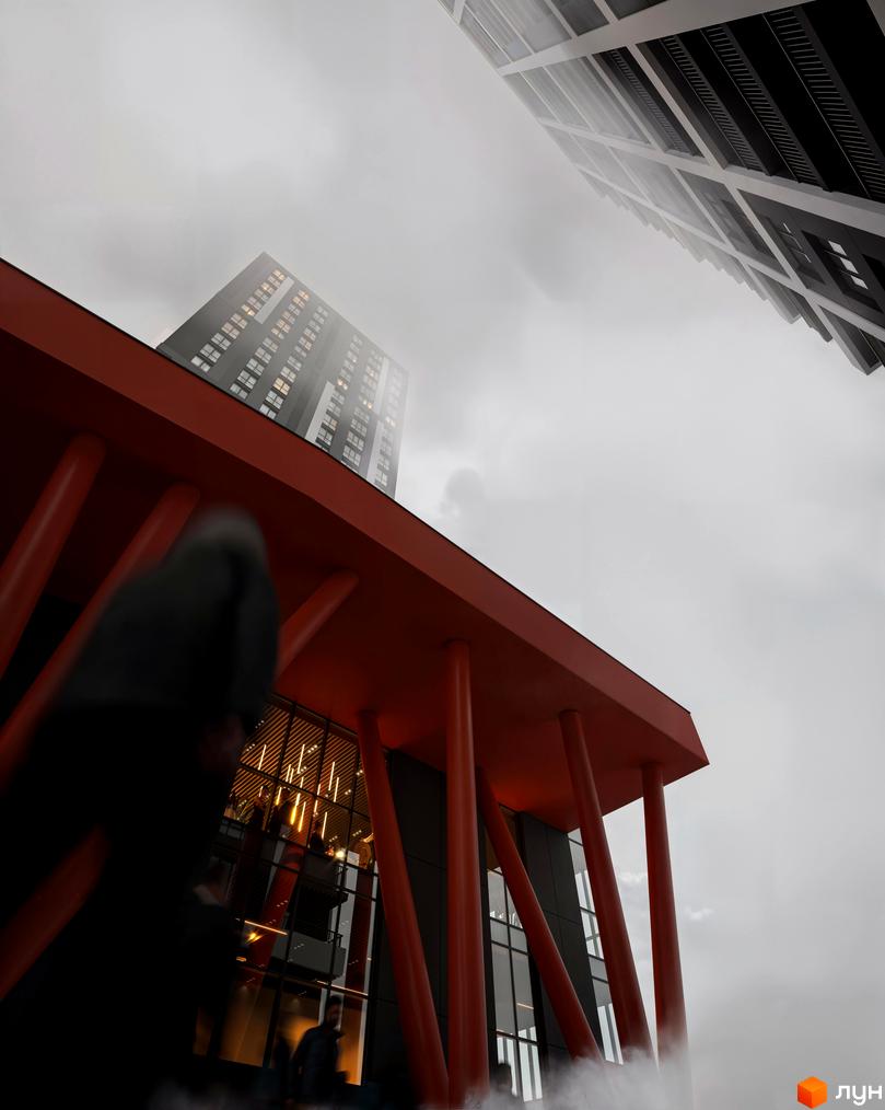 Житловий комплекс Avalon Up: фасади будинків з панорамними вікнами та червоними опорами. Сучасна архітектура на фоні туманного неба.