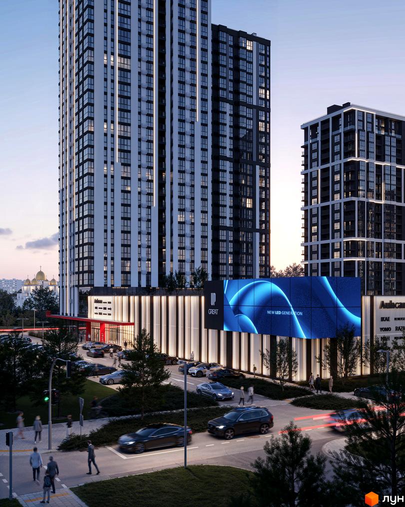 Avalon Up – новобудова з високими будівлями, численними вікнами та вертикальним освітленням. Навколо – дорога, автомобілі та великий LED-екран.