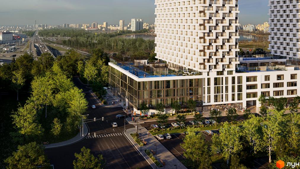 Зображення фасаду та прибудинкової території BOSTON Creative House. На передньому плані дорога з пішохідним переходом та зелені насадження.