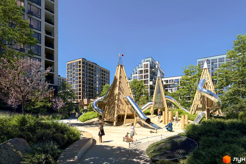 Багатоповерхові будинки Новобудови Dnipro Island. Прибудинкова територія має дитячий майданчик з дерев'яними конструкціями та металевими гірками.