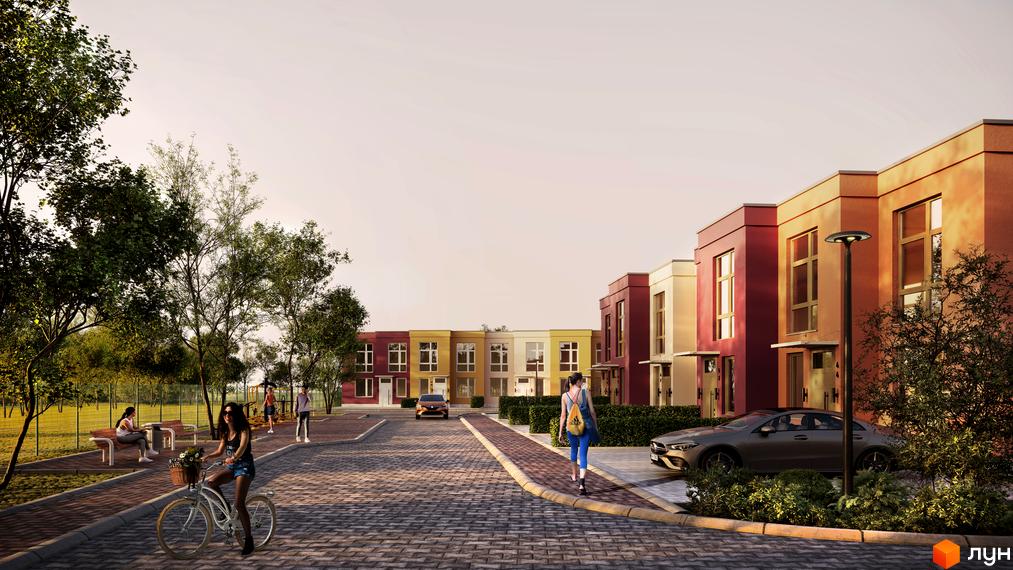 Житловий парк Cuvee Village. Ряд будинків з великими вікнами, перед будинками брукована дорога, зелені насадження та вуличне освітлення.