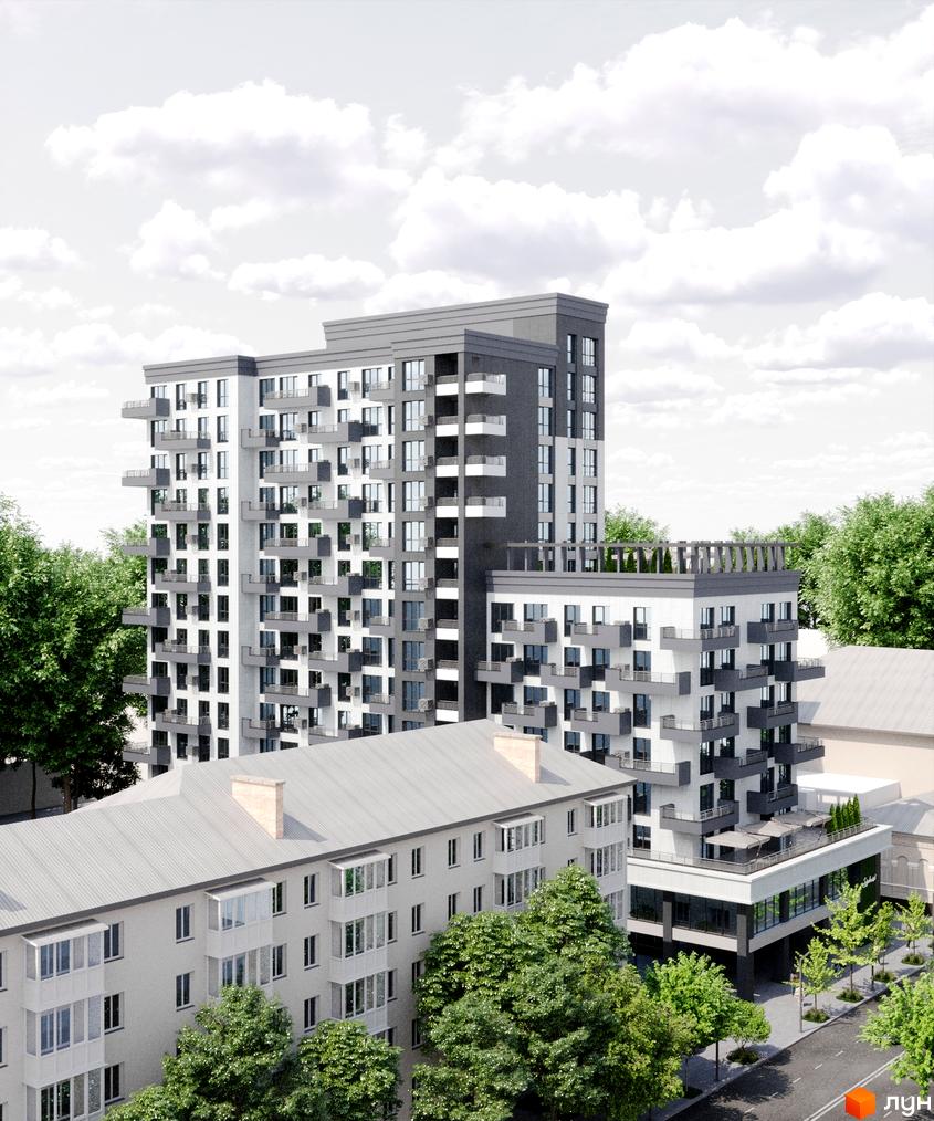 Багатоповерховий будинок з балконами та терасами. Поряд розташовані інші будівлі, дерева та дорога.