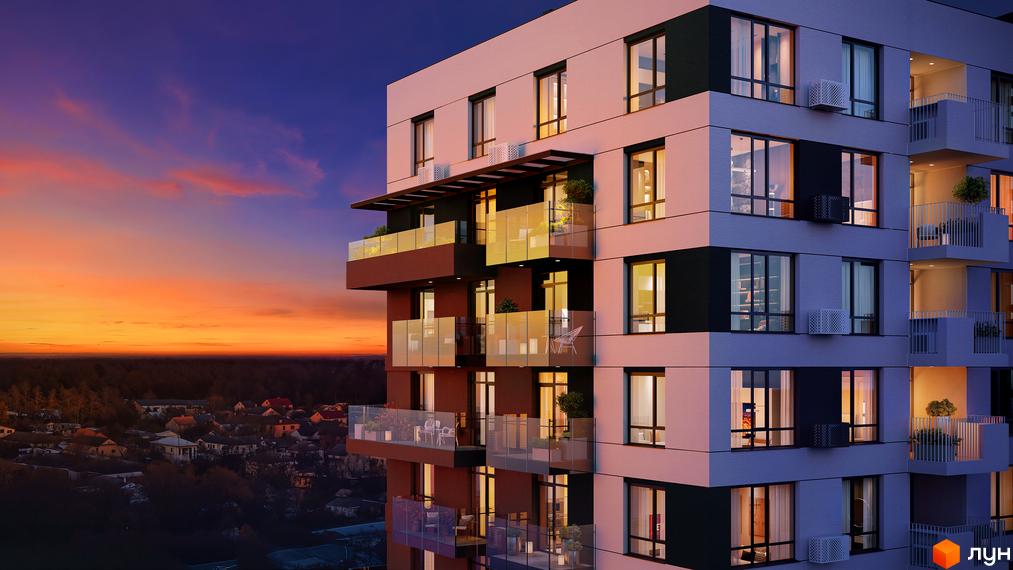 Житловий комплекс FORREST на заході сонця з видом на міську забудову та ліс. Фасад будинку має світлі та темні секції з великими вікнами та скляними балконами.