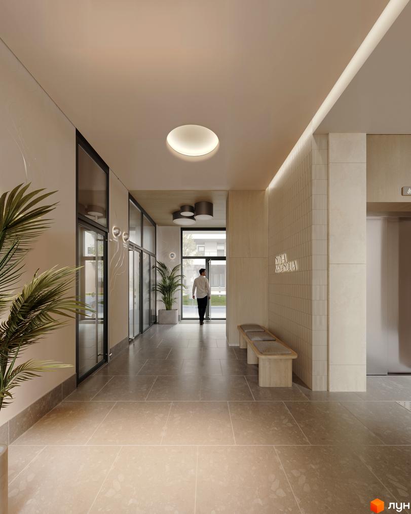 Сучасний інтер'єр холу житлового комплексу Avalon Magnolia з елегантним дизайном та освітленням. Простір доповнює лаконічна лавка та зелені рослини.