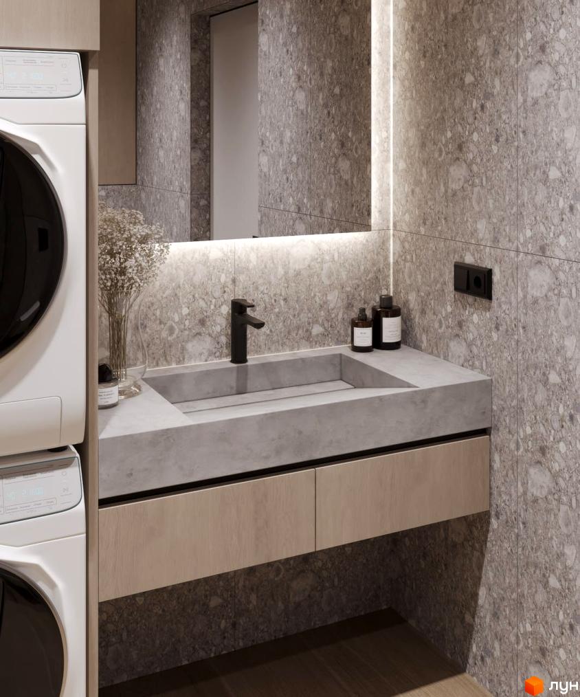 Інтер'єр ванної кімнати в КМ VIVA-CHERNIVTSI з сучасною пральною машиною та раковиною на стільниці з натурального каменю.