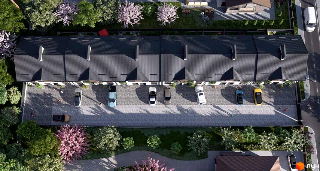 Вигляд з висоти пташиного польоту на таунхауси F9. На території комплексу є парковка для автомобілів та зелені насадження.