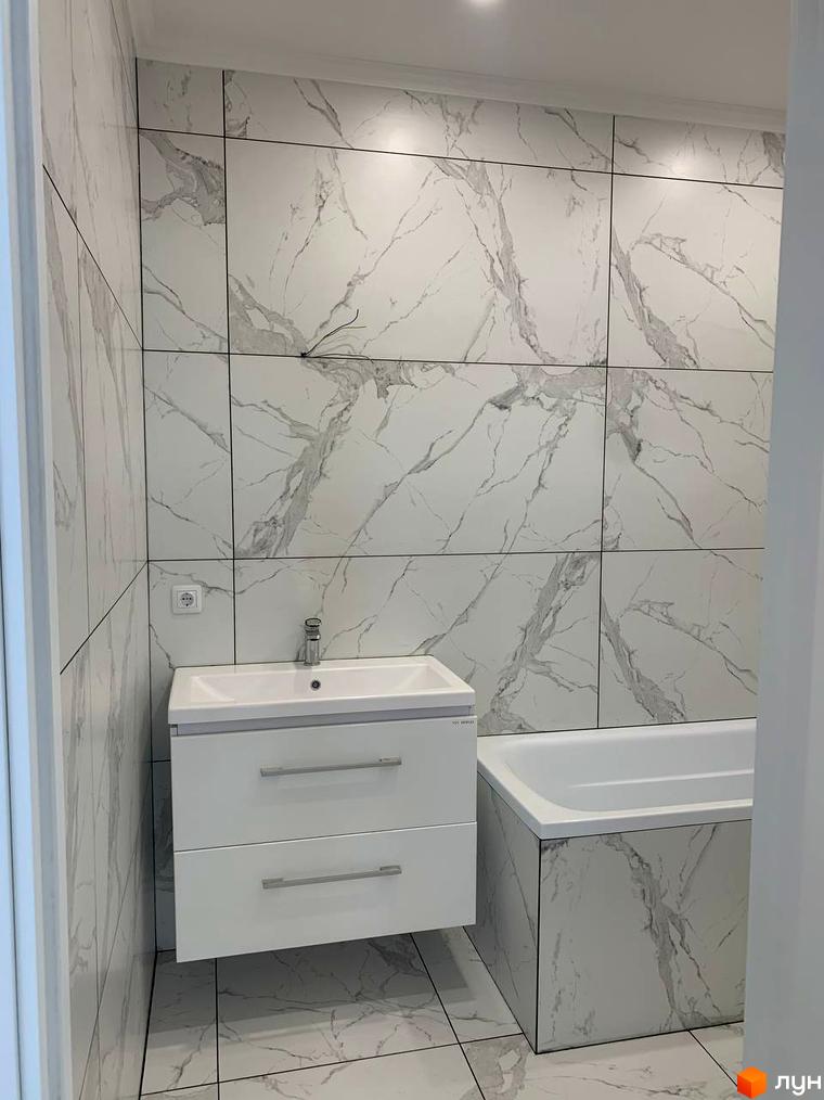 Ванна кімната з мармуровим оздобленням стін та підлоги, білою раковиною та ванною. Клубний будинок „На Макіївській“.