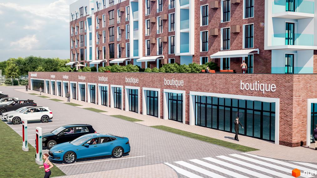 Житловий комплекс Володимир Сіті з цегляним фасадом та магазинами на першому поверсі. Поруч парковка з електрозарядками та пішохідна зона.