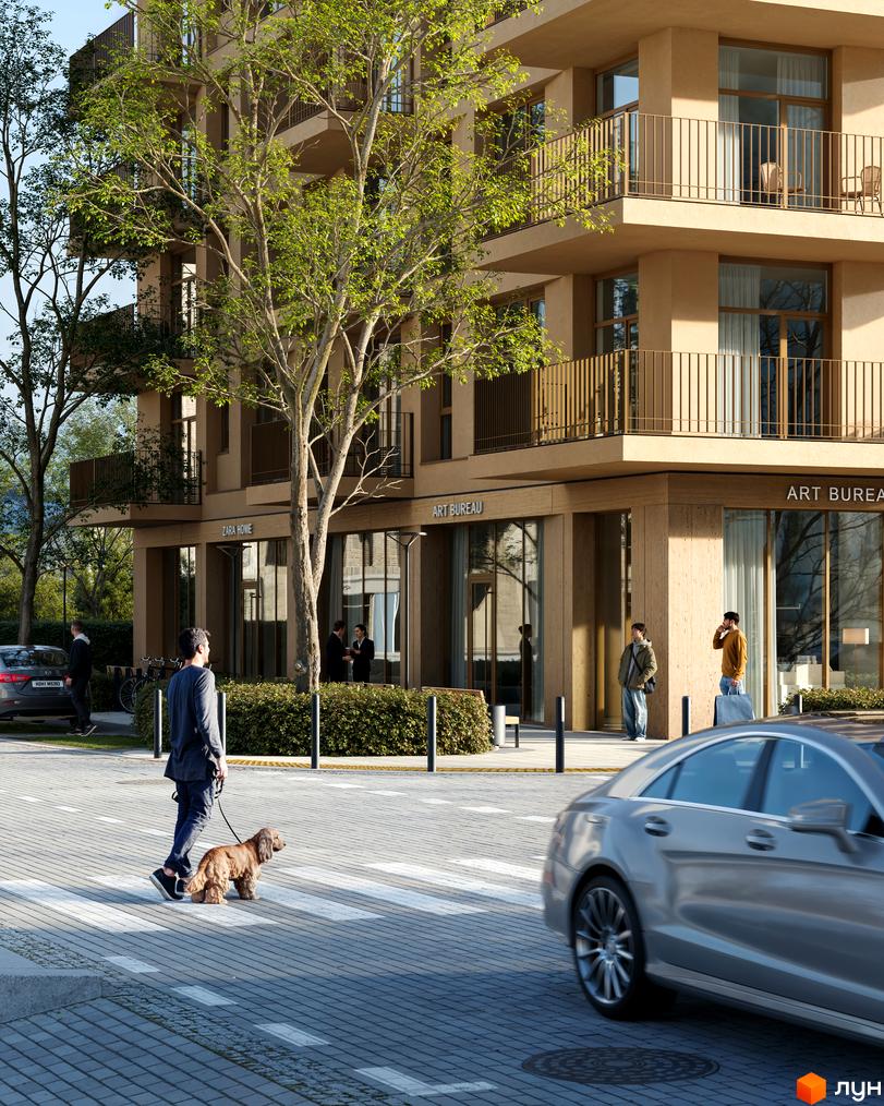 Avalon Yard Club - житловий комплекс з фасадами бежевого кольору, балконами та зеленою прибудинковою територією. На зображенні видно пішохідний перехід та людей.