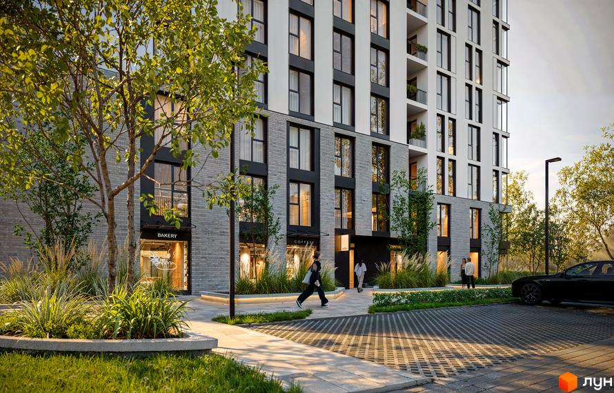 Комплекс Moro: багатоповерховий будинок з сірим цегляним та світлим фасадом, а також облаштована прибудинкова територія з зеленими насадженнями.