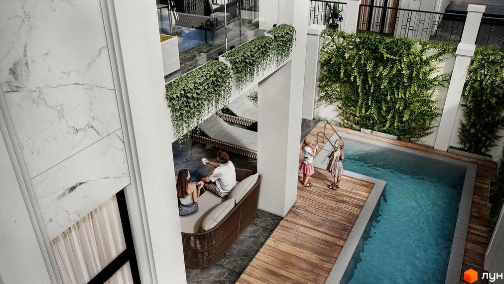 Вид на басейн та котеджний комплекс КМ МАЄТОК. Простора тераса з деревʼяним покриттям та зеленню навколо басейну.